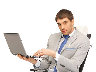 Image showing young businessman sitting in chair with laptop