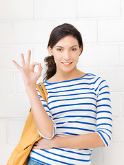 Image showing lovely teenage girl showing ok sign