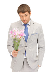 Image showing handsome man with flowers in hand