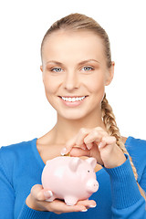 Image showing lovely woman with piggy bank and money