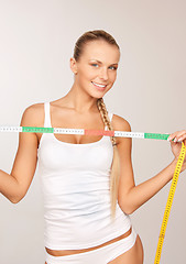 Image showing young beautiful woman with measure tape