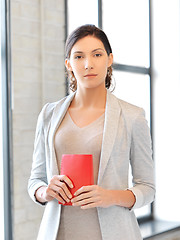 Image showing calm and serious woman with book