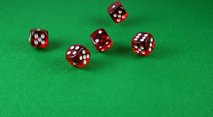 Image showing An Action shot of 5 dice thrown onto the table