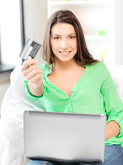 Image showing happy woman with laptop computer and credit card