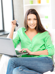 Image showing happy woman with laptop computer and credit card