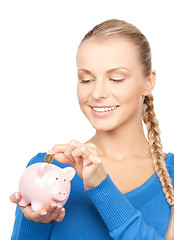 Image showing lovely woman with piggy bank and money