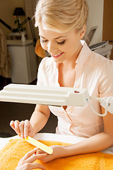 Image showing woman having a manicure at the salon