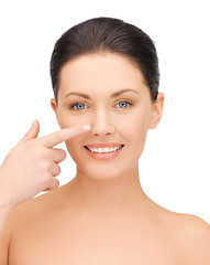 Image showing beautiful woman pointing to nose