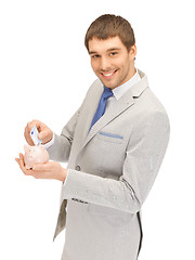 Image showing man with piggy bank and money