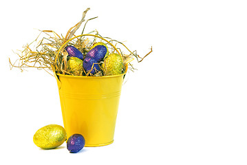 Image showing yellow bucket with yellow and purple easter eggs