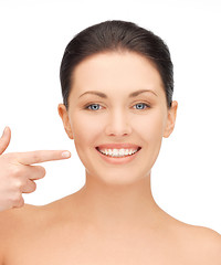 Image showing beautiful woman pointing to teeth