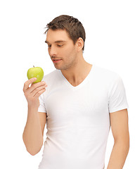 Image showing man in white shirt with green apple