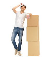 Image showing handsome builder with big boxes