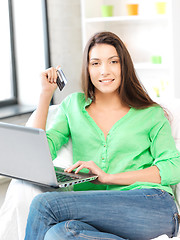 Image showing happy woman with laptop computer and credit card