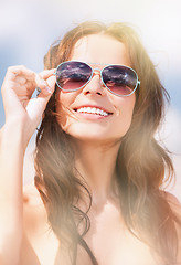 Image showing beautiful woman in sunglasses on a beach
