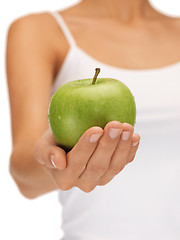 Image showing female hands with green apple