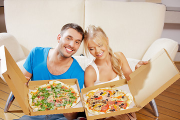 Image showing romantic couple eating pizza at home