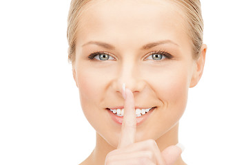 Image showing happy woman with finger on lips