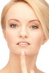 Image showing beautiful woman pointing to chin