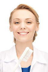 Image showing attractive female doctor with toothbrush