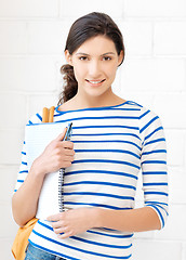 Image showing happy and smiling teenage girl with big notepad