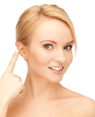 Image showing beautiful woman pointing to ear