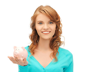 Image showing teenage girl with piggy bank