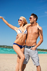 Image showing happy couple in sunglasses on the beach