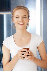 Image showing happy and smiling teenage girl with glass of cola