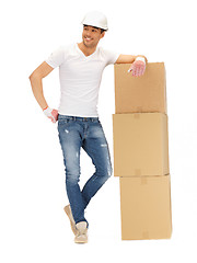 Image showing handsome builder with big boxes