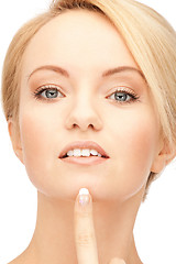 Image showing beautiful woman pointing to chin