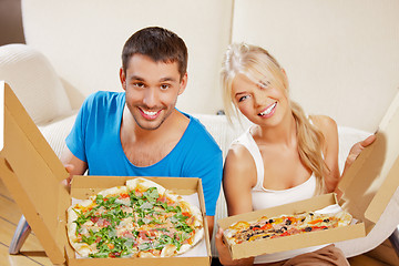 Image showing romantic couple eating pizza at home