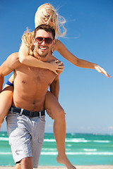 Image showing happy couple in sunglasses on the beach