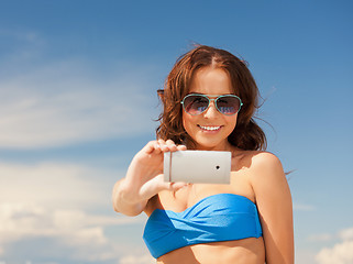 Image showing happy woman with phone on the beach