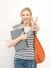 Image showing smiling teenage girl with laptop