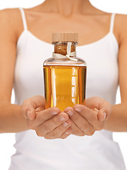 Image showing female hands with oil bottle