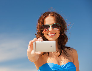 Image showing happy smiling woman using phone camera