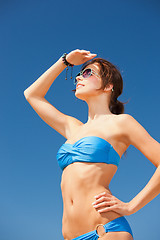 Image showing happy woman in sunglasses on the beach