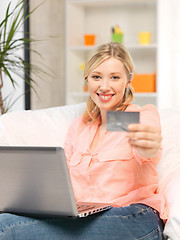 Image showing happy woman with laptop computer and credit card