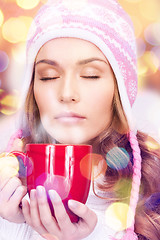 Image showing beautiful woman with red mug