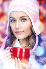 Image showing beautiful woman with red mug