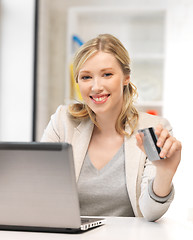 Image showing happy woman with laptop computer and credit card