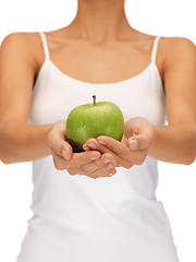 Image showing female hands with green apple