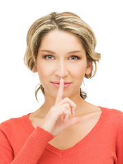 Image showing happy woman with finger on lips