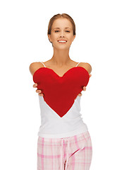 Image showing happy and smiling woman with heart-shaped pillow