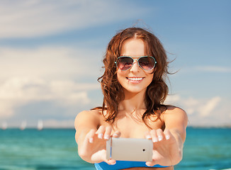 Image showing happy smiling woman using phone camera