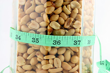 Image showing Peanuts in a Jar with Tape Measure