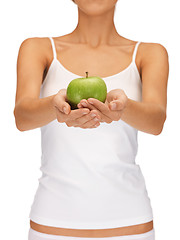 Image showing female hands with green apple