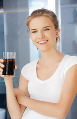 Image showing happy and smiling teenage girl with glass of cola