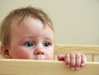 Image showing baby looking from his bed